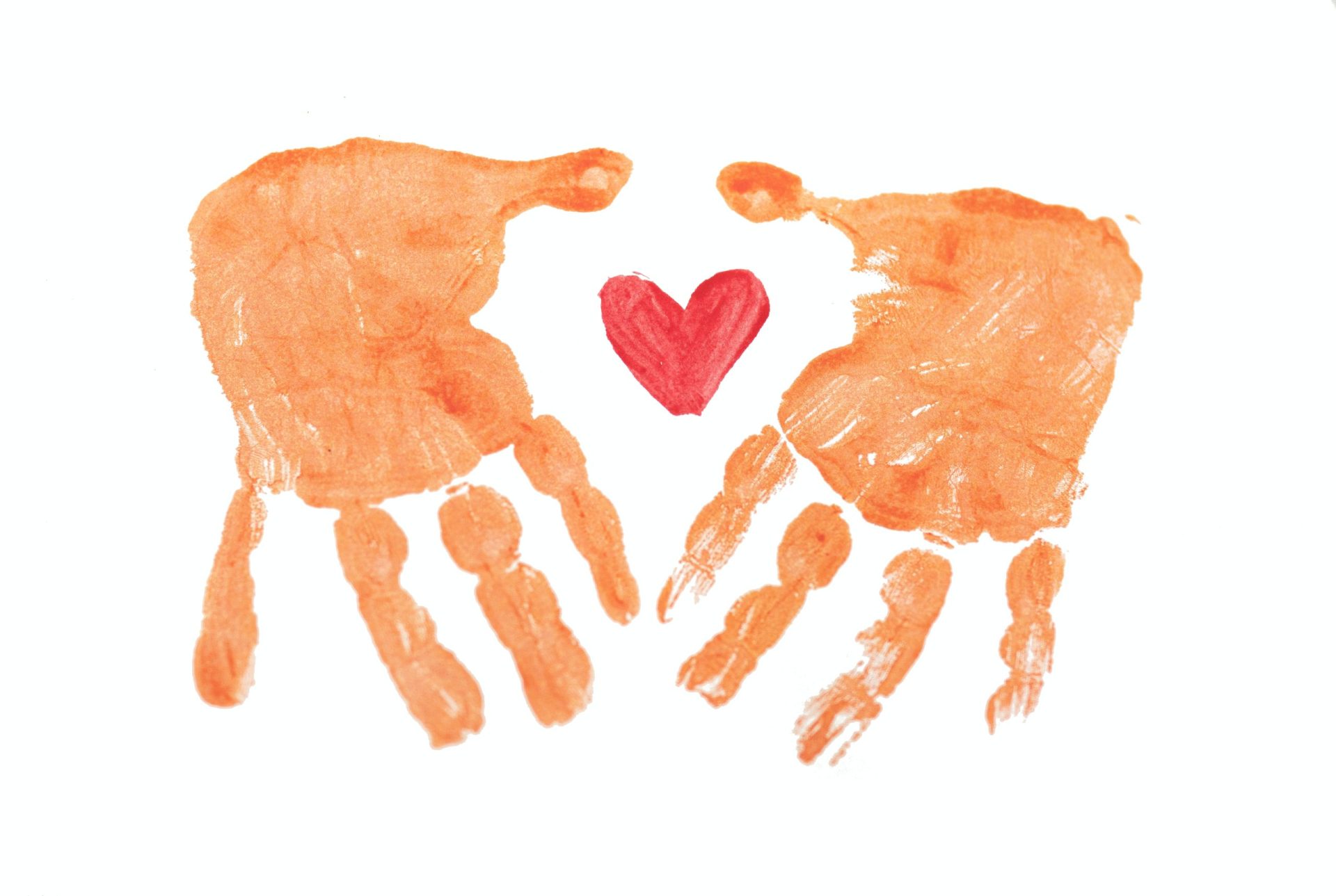Painted handprints around painted heart